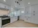 Well-lit kitchen with white cabinets, stainless steel appliances, and quartz countertops, perfect for culinary enthusiasts at 1852 E Viking Rd, Las Vegas, NV 89169