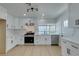 Modern, white kitchen with stainless steel appliances, quartz countertops, and ample cabinet space for storage and meal prep at 1852 E Viking Rd, Las Vegas, NV 89169