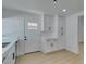 Bright kitchen features white cabinets, white countertops, and an entry door at 1852 E Viking Rd, Las Vegas, NV 89169