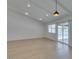 Bright living room with hardwood floors, modern lighting and glass doors to outside at 1852 E Viking Rd, Las Vegas, NV 89169
