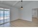 Bright living room features modern lighting fixtures and glass doors that lead to a pool at 1852 E Viking Rd, Las Vegas, NV 89169