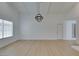Bright and open living room with new flooring, a modern light fixture, and ample space for entertaining guests at 1852 E Viking Rd, Las Vegas, NV 89169