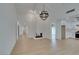 Spacious living room featuring light floors, fireplace, and modern chandelier at 1852 E Viking Rd, Las Vegas, NV 89169