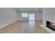 Bright living room featuring new flooring, a cozy fireplace, and sliding glass doors to provide seamless indoor-outdoor living at 1852 E Viking Rd, Las Vegas, NV 89169