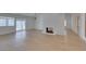 Spacious living room with new flooring, a modern fireplace, and sliding glass doors that let in ample natural light at 1852 E Viking Rd, Las Vegas, NV 89169