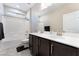 Bathroom features a double sink vanity, with white counters, dark wood cabinets and shower-tub combo at 19 Cresta Villa Ct, Henderson, NV 89011