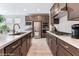 Modern kitchen featuring stainless appliances, a white countertop island, and dark cabinets at 19 Cresta Villa Ct, Henderson, NV 89011