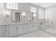 Modern bathroom with dual sinks, marble counters, and a spacious walk-in shower at 1950 Colvin Run Dr, Henderson, NV 89052