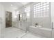 Luxurious bathroom with a double vanity, a glass-enclosed shower, and elegant tile work for a spa-like retreat at 1950 Colvin Run Dr, Henderson, NV 89052