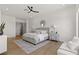 Spacious bedroom with ample natural light, ceiling fan, wood floors, and neutral decor at 1950 Colvin Run Dr, Henderson, NV 89052
