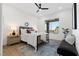 Cozy bedroom with wood floors, ceiling fan, contemporary decor, and backyard pool view at 1950 Colvin Run Dr, Henderson, NV 89052