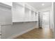 Large walk-in closet with custom shelving, hanging racks and laminate flooring at 1950 Colvin Run Dr, Henderson, NV 89052
