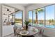 Cozy dining area featuring a round table, scenic views, and access to the outdoor patio and pool area at 1950 Colvin Run Dr, Henderson, NV 89052