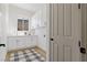 Bright laundry room features white cabinets and countertops, a window, and modern finishes at 1950 Colvin Run Dr, Henderson, NV 89052