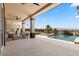 Expansive covered patio includes an outdoor kitchen, lounge area, and access to a refreshing pool at 1950 Colvin Run Dr, Henderson, NV 89052