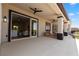 Covered patio with an outdoor kitchen, lounge area, and a glimpse into the modern interior at 1950 Colvin Run Dr, Henderson, NV 89052