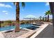 Enjoy a serene pool with spa, rock features, and umbrella overlooking a lovely view at 1950 Colvin Run Dr, Henderson, NV 89052