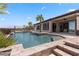 Beautiful backyard pool with spa, and lush landscaping, ideal for outdoor entertaining and relaxation at 1950 Colvin Run Dr, Henderson, NV 89052