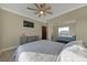 This bedroom has a ceiling fan and a large mirror creating a spacious effect at 1999 Oliver Springs St, Henderson, NV 89052