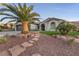 Well-manicured front yard with mature palm trees and stepped stone walkway to the front entrance at 1999 Oliver Springs St, Henderson, NV 89052