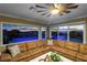 Living room with brown sectional sofa and a view of the pool and sunset at 1999 Oliver Springs St, Henderson, NV 89052