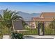 Scenic patio featuring a lounge chair, ambient lighting, and captivating mountain views in the background at 1999 Oliver Springs St, Henderson, NV 89052