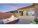 Outdoor living space featuring fire pit, pavers, privacy wall, sliding glass door to home interior at 2069 Alto Vista Dr, Henderson, NV 89052