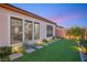Lush backyard featuring artificial turf, stone walkway and colorful landscaping, providing a serene outdoor retreat at 2069 Alto Vista Dr, Henderson, NV 89052