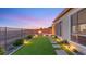 Outdoor living space with fire pit, turf, and desert views create a private and inviting atmosphere at 2069 Alto Vista Dr, Henderson, NV 89052