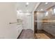 Bathroom with a stone-tiled shower, granite vanity, and stone-tiled floors at 2069 Alto Vista Dr, Henderson, NV 89052