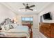 A bedroom with a ceiling fan, carpet, and two dressers; a window looks out onto the landscape at 2069 Alto Vista Dr, Henderson, NV 89052