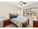Bright bedroom with mountain view through large window; has a queen bed and wood furniture at 2069 Alto Vista Dr, Henderson, NV 89052