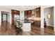 Modern kitchen with stainless steel appliances, wood cabinets, a center island with seating, and wood flooring at 2069 Alto Vista Dr, Henderson, NV 89052