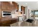 The kitchen has stainless steel appliances and wood cabinets, plus a view to the side of the home at 2069 Alto Vista Dr, Henderson, NV 89052