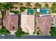 Drone's eye view showing the layout with pools and landscaping of three residences in close proximity at 2113 Scarlet Rose Dr, Las Vegas, NV 89134