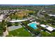 Overhead view featuring community pool, baseball diamond, basketball court, and play area surrounded by trees at 2113 Scarlet Rose Dr, Las Vegas, NV 89134
