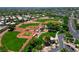 Aerial view showcases baseball fields in a beautifully maintained community park surrounded by trees at 2113 Scarlet Rose Dr, Las Vegas, NV 89134