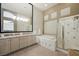 Elegant bathroom featuring double sinks, jacuzzi tub, and glass-enclosed shower at 2113 Scarlet Rose Dr, Las Vegas, NV 89134
