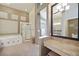 Stylish bathroom with tub, shower, and vanity area, offering a spa-like experience at 2113 Scarlet Rose Dr, Las Vegas, NV 89134