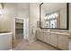 Bright bathroom with double vanity, large mirror and access to walk-in closet at 2113 Scarlet Rose Dr, Las Vegas, NV 89134