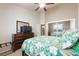 Comfortable bedroom with dresser, TV, and ceiling fan, providing a relaxing retreat at 2113 Scarlet Rose Dr, Las Vegas, NV 89134