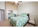 Bright bedroom featuring a ceiling fan, closet with mirrored doors, and comfortable bed at 2113 Scarlet Rose Dr, Las Vegas, NV 89134