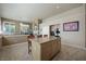 Bright kitchen flows into the living space, featuring an island with barstools and modern appliances at 2113 Scarlet Rose Dr, Las Vegas, NV 89134