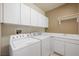 Convenient laundry room with modern washer and dryer, plus ample storage space at 2113 Scarlet Rose Dr, Las Vegas, NV 89134