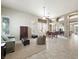 Spacious living room with an open concept layout, neutral paint, and updated tile and carpet at 2113 Scarlet Rose Dr, Las Vegas, NV 89134