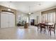 Bright living room featuring tile floors, plantation shutters, and dining area at 2113 Scarlet Rose Dr, Las Vegas, NV 89134