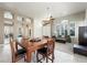 Bright living room featuring tile floors, plantation shutters, and dining area at 2113 Scarlet Rose Dr, Las Vegas, NV 89134