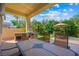 Cozy outdoor patio with a built-in grill, dining area, and scenic views of the backyard at 2113 Scarlet Rose Dr, Las Vegas, NV 89134