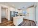 Modern kitchen featuring white cabinetry, stainless steel appliances, an island, and wood floors at 25 Barbara Ln # 42, Las Vegas, NV 89183