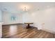Open living space with modern light fixture, wood floors, and large bright window at 25 Barbara Ln # 42, Las Vegas, NV 89183